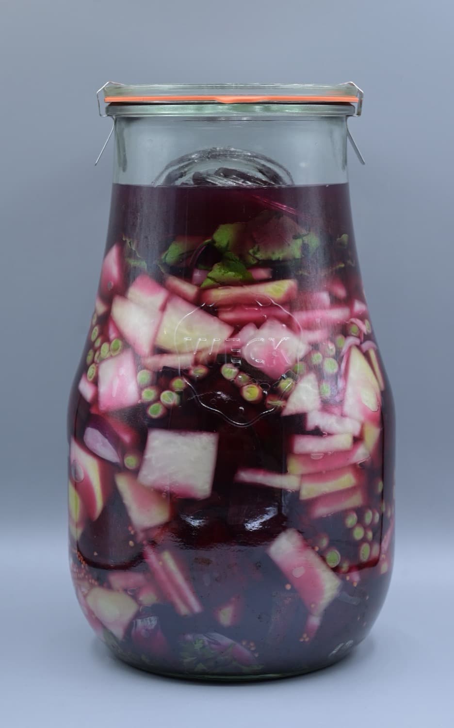 Granos de cacao fermentándose bajo hojas